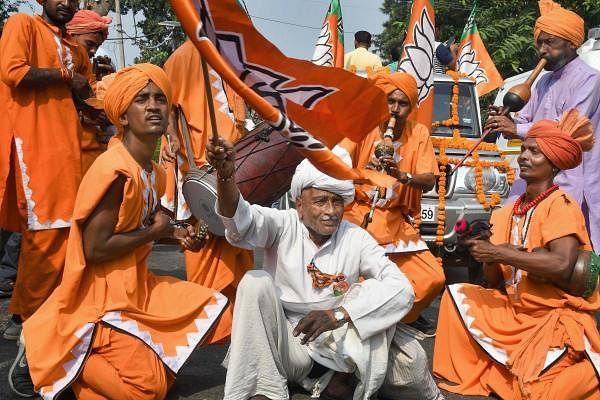 Supporters of BJP candidate from Gharaunda, Harvinder Singh Kalyan celebrate his win in the Assembly election, in Karnal, Thursday, Oct. 24, 2019. (PTI Photo)
