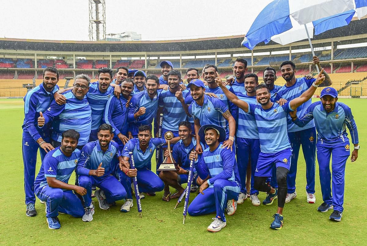 Karnataka team celebrates with the trophy after their victory against Tamil Nadu in the finals of the Vijay Hazare Trophy tournamentg in Bengaluru, Friday, Oct. 25, 2019. (PTI Photo)