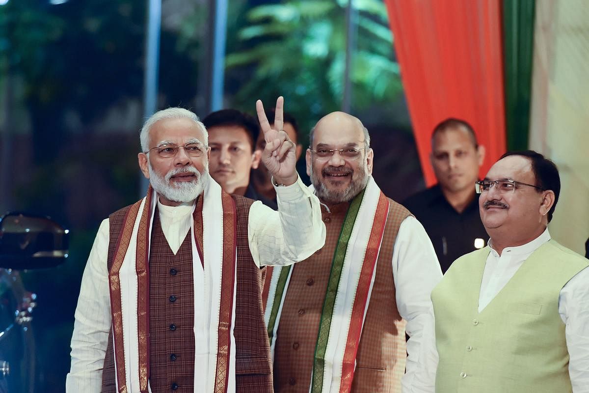 Prime Minister Narendra Modi arrives to address his supporters at the BJP headquarters in New Delhi on Thursday. PTI
