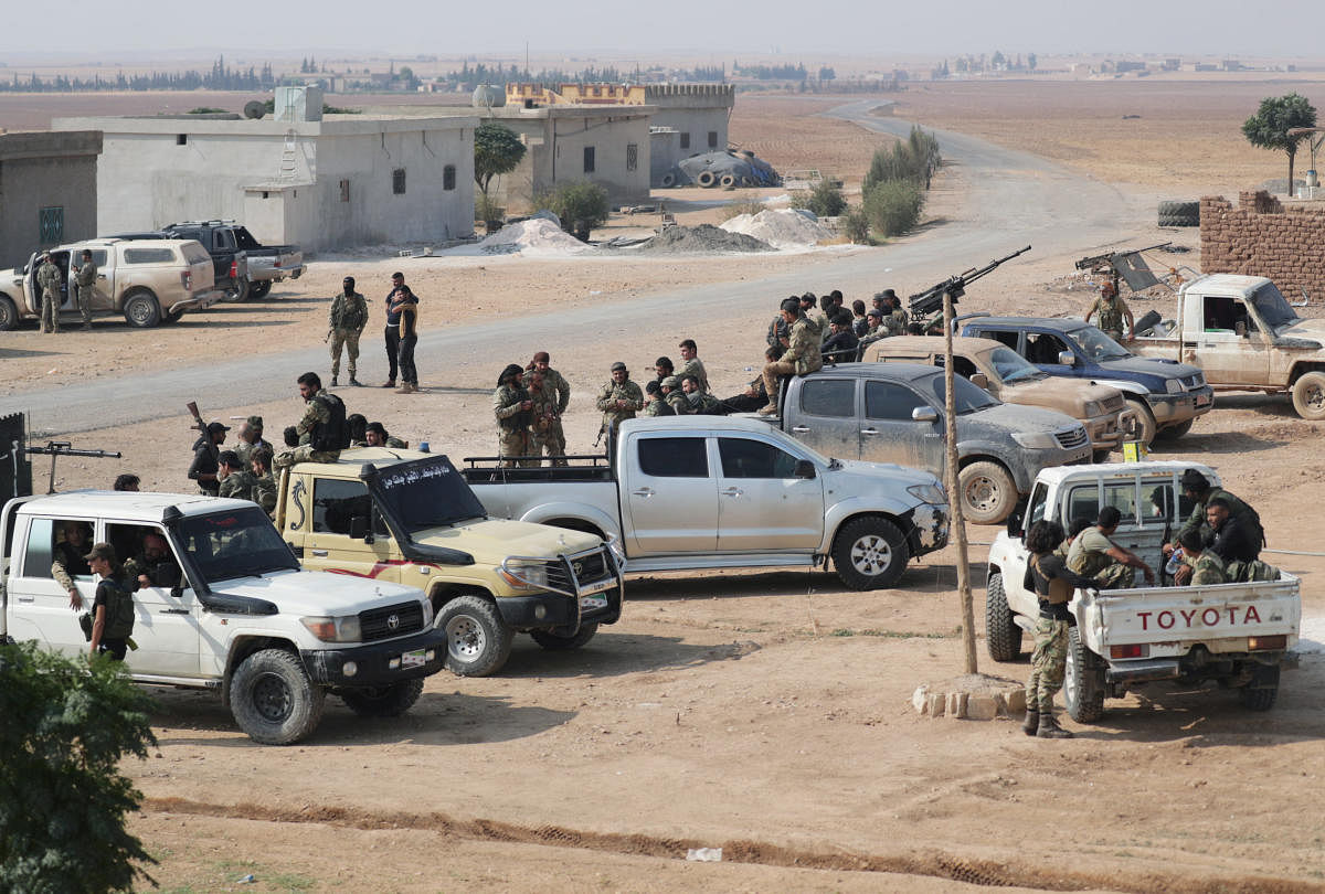 Turkey-backed Syrian rebel fighters gather near the border town of Tal Abyad. (REUTERS Photo)