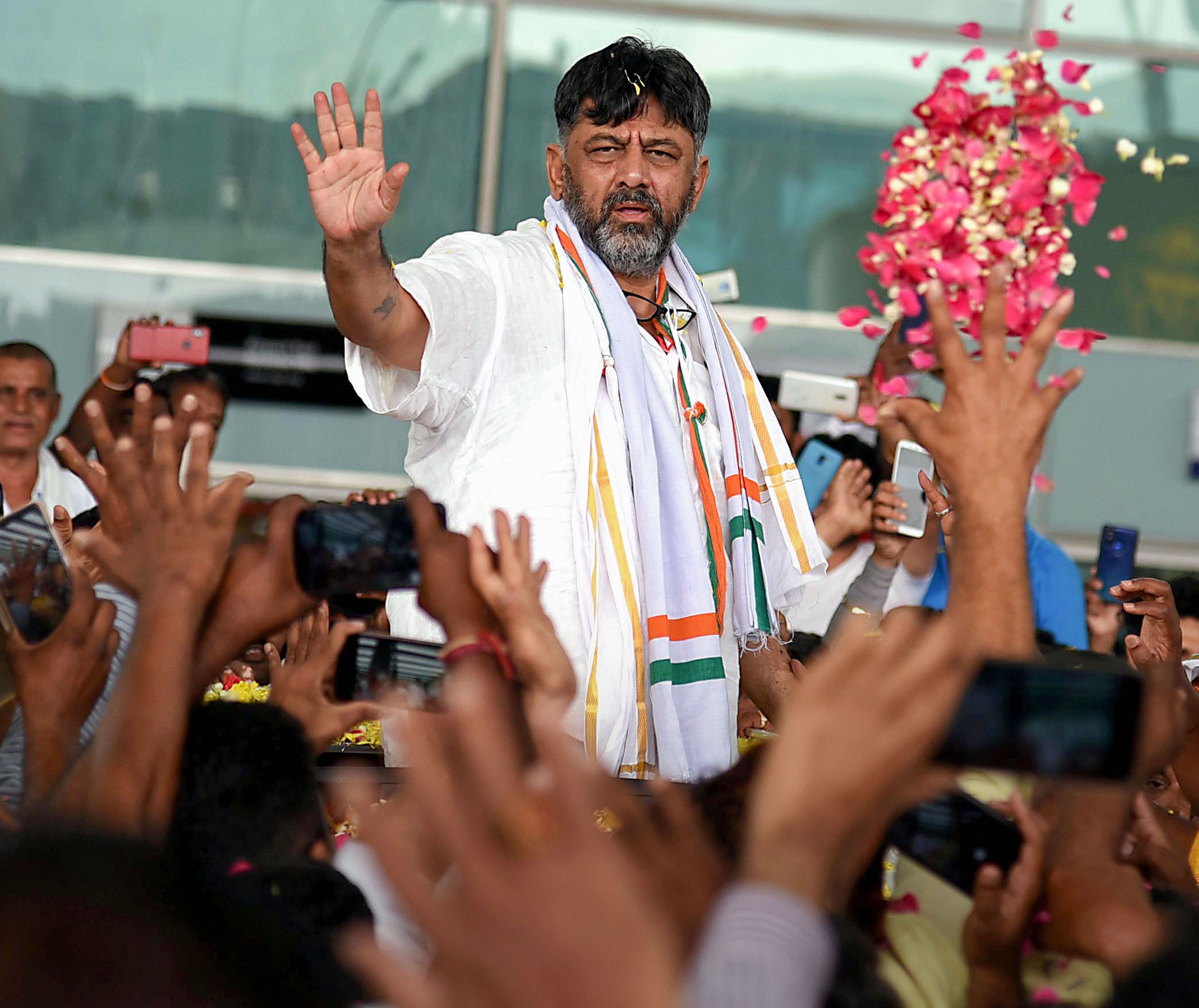 Congress leader D K Shivakumar being welcomed by his supporters on his arrival in Bengaluru. (PTI Photo)