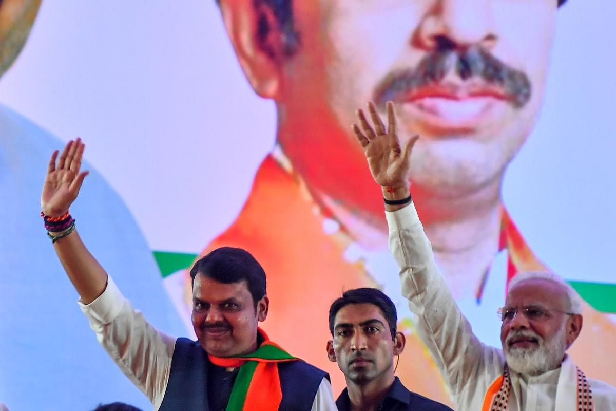 India's Prime Minister Narendra Modi (R) gestures along with Devendra Fadnavis (L). AFP file photo