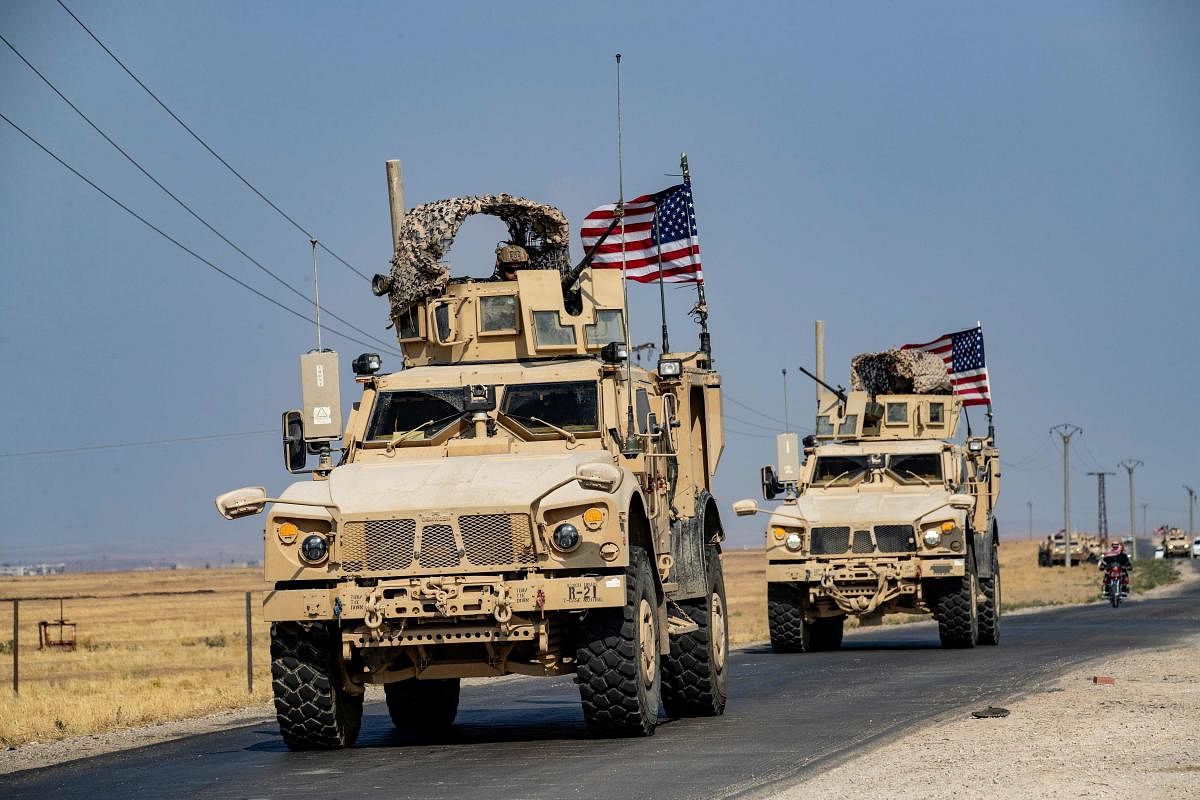 US military vehicles, part of a convoy arriving from northern Iraq, drive through the countryside of Syria's northeastern city of Qamishli on October 26, 2019. Photo/AFP