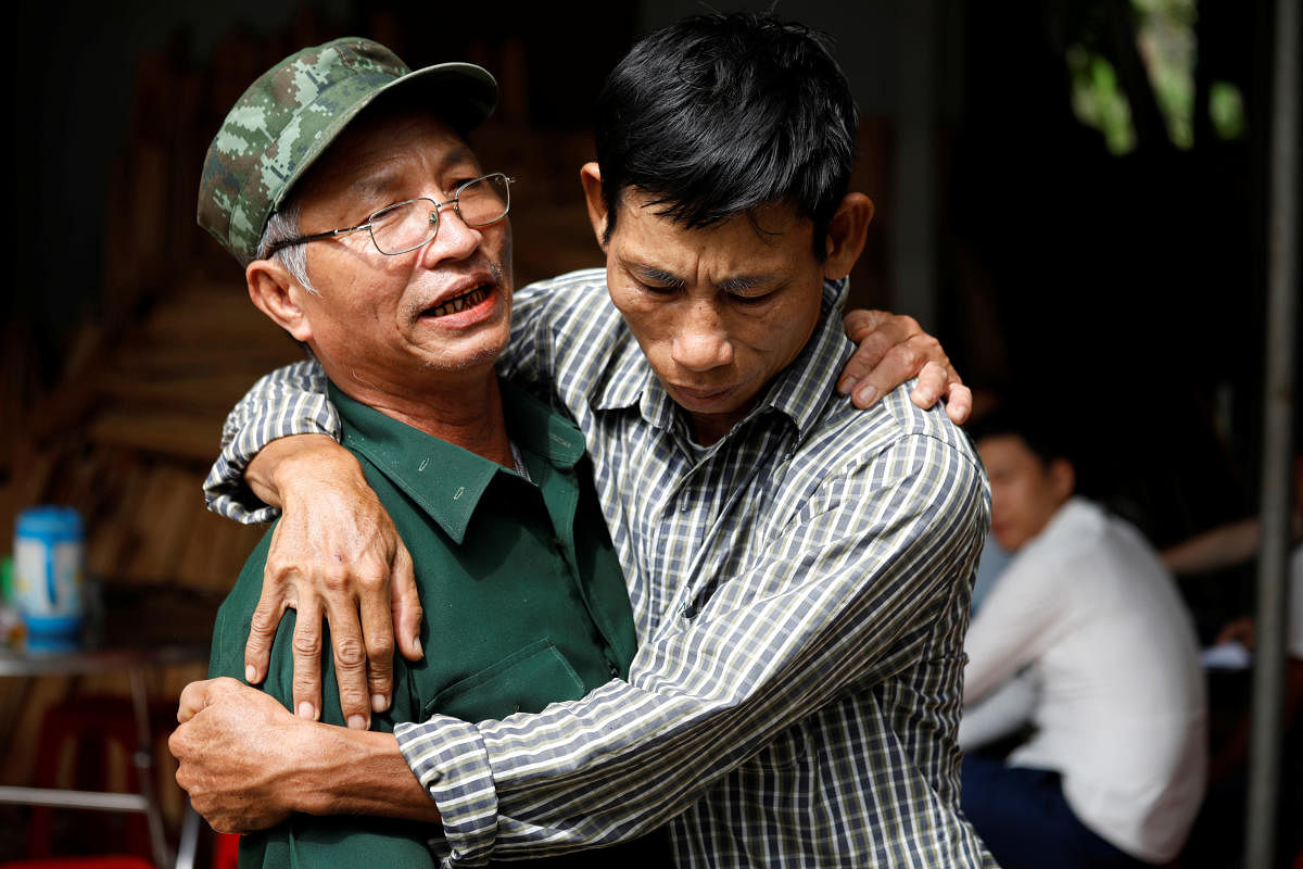 Nguyen Dinh Gia, father of Vietnamese Joseph Nguyen Dinh Luong who is one of the suspected victims of the 39 people found dead in a refrigerated truck in Britain, is embraced by a friend at his home in Ha Tinh province, Vietnam October 27, 2019. REUTERS/Kham