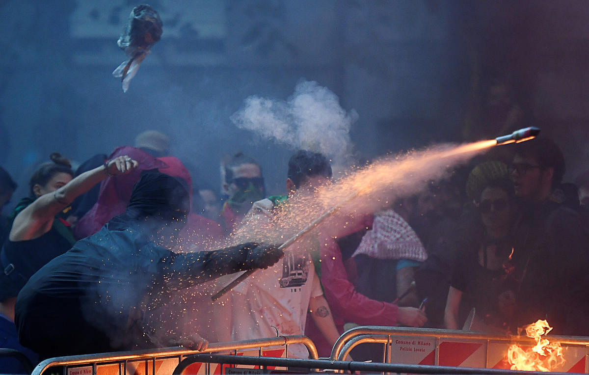 A protester fires a rocket during a pro-Kurdish demonstration against Turkey's military action in northeastern Syria. (Reuters Photo)