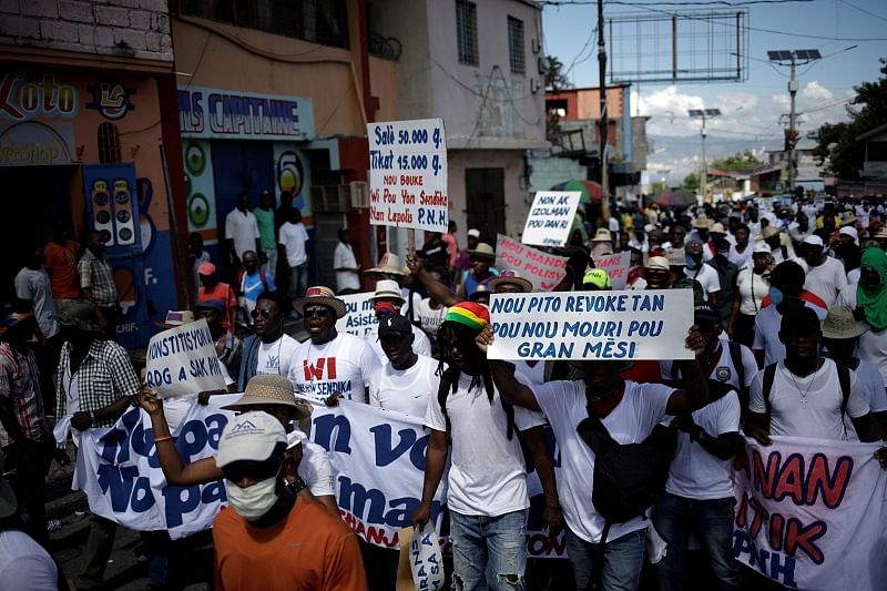 People take part in a demonstration organised by police officers to demand improvements in their labour conditions, in the streets of Petion Ville, Port-au-Prince, Haiti. (Reuters Photo)