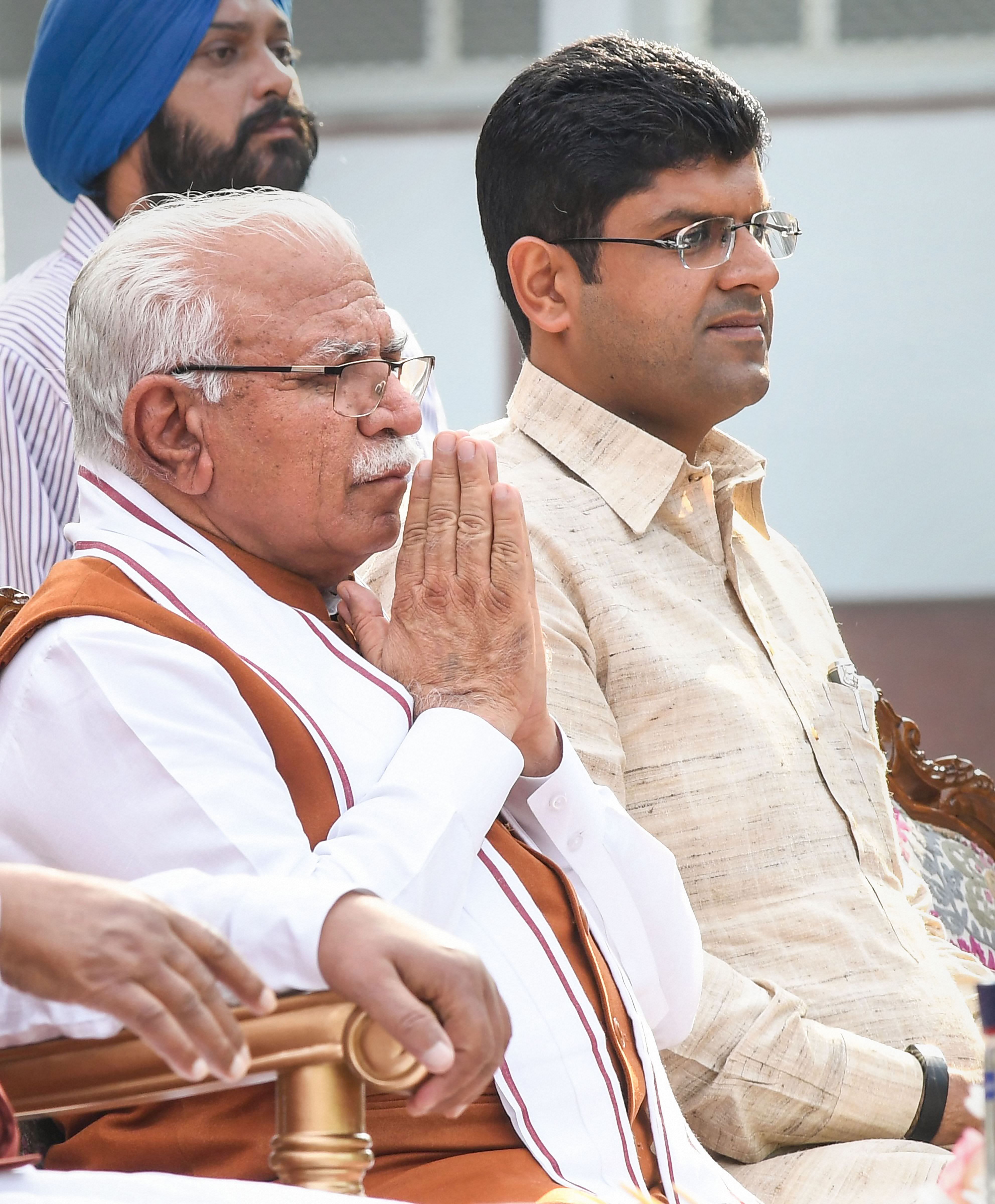 Haryana's new Chief Minister Manohar Lal Khattar and Deputy Chief Minister Dushyant Chautala after taking oath during a swearing-in ceremony, in Chandigarh. (PTI Photo)