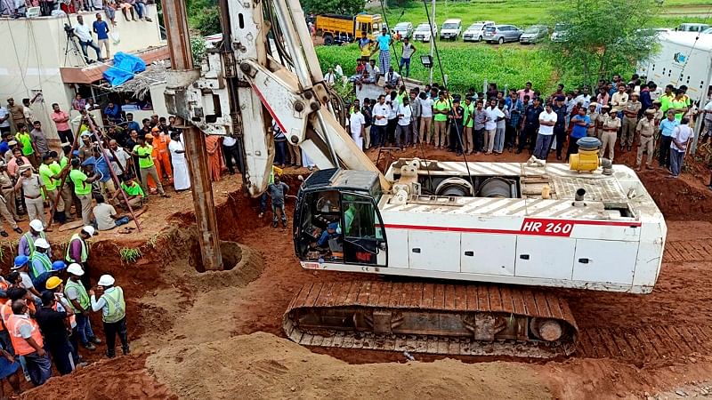 Operation still underway to rescue the 2-year-old Sujith Wilson who fell into a 25-feet deep borewell in Nadukattupatti, Tiruchirappalli district Yesterday, the boy fell further down the borewell, currently stuck at 100 feet. (PTI PHoto)