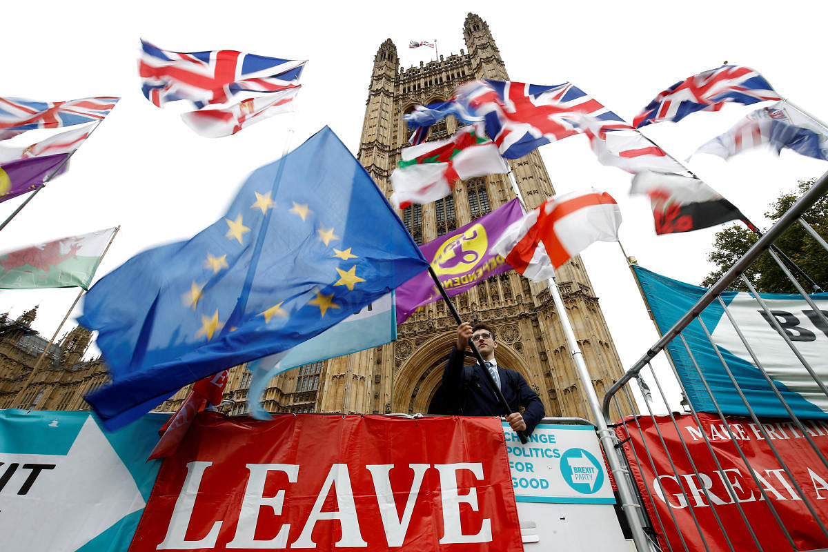 An anti-Brexit protester waves an EU flag outside the Houses of Parliament in London. (Reuters Photo)