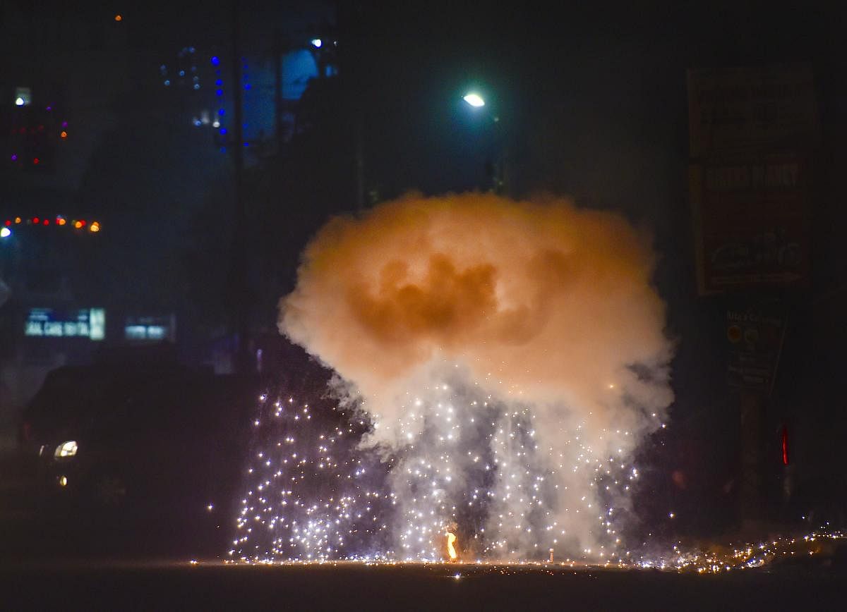 Smoke rises as people burn crackers during 'Diwali' celebrations, in New Delhi, Sunday, Oct. 27, 2019. (PTI Photo)