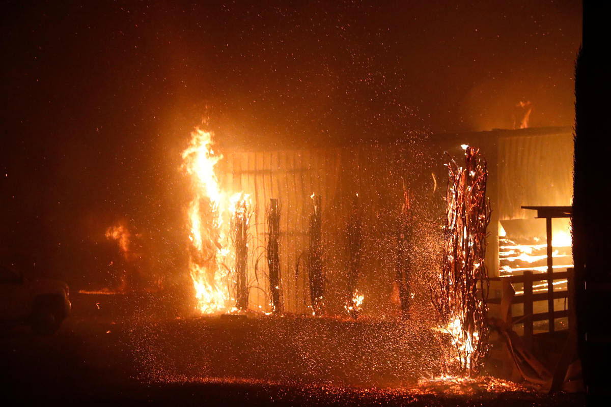 A burning structure is seen during the wind-driven Kincade Fire in Windsor, California. (Reuters Photo)