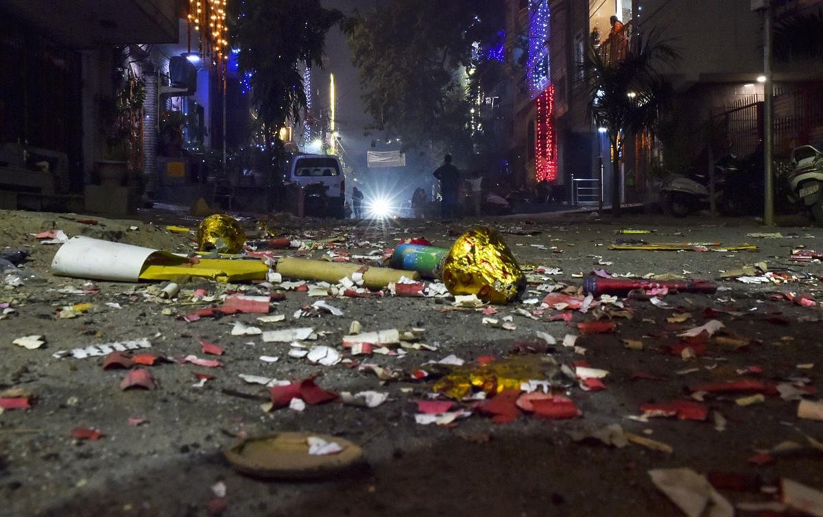 A view of a street littered with firecrackers waste during Diwali celebrations, in New Delhi on  Sunday. (PTI Photo)