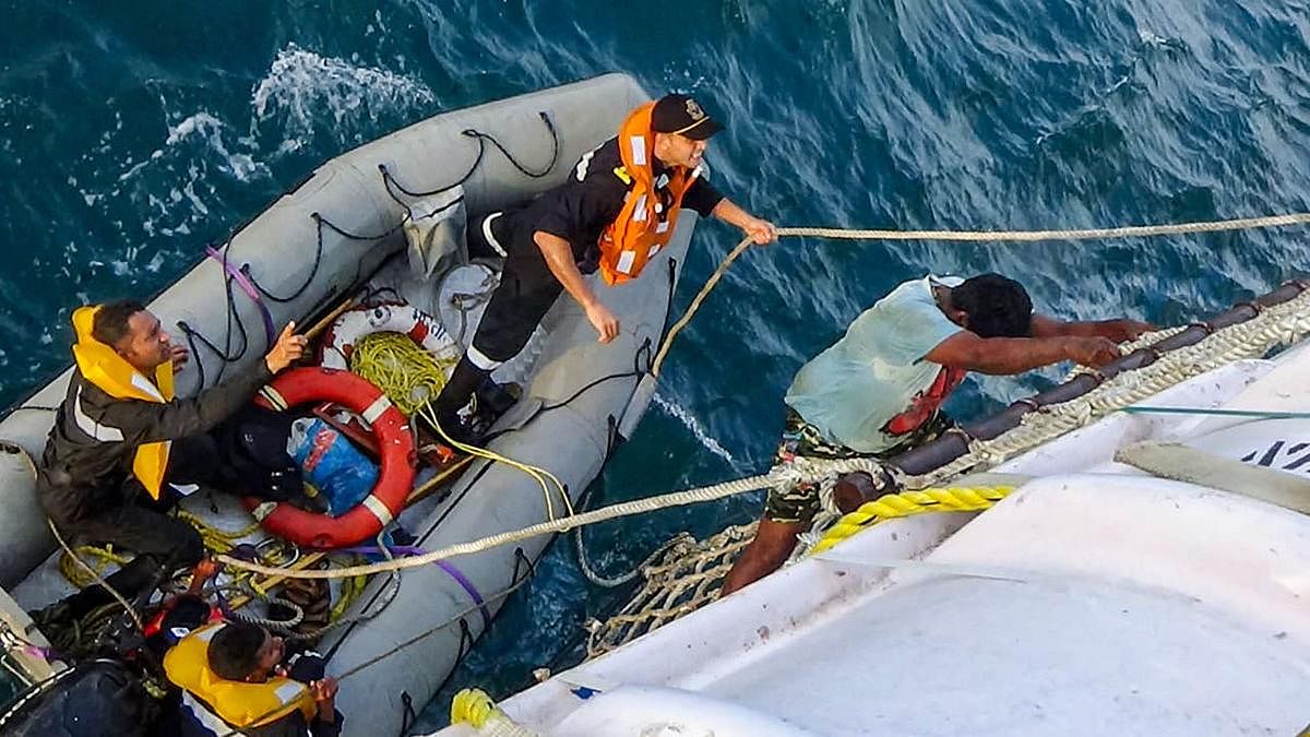In this photo sourced from Twitter, Indian Coast Guard personnel rescue fishermen stranded at sea off West coast following super cyclonic storm Kyarr. (Twitter/PTI Photo)