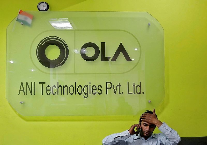 An employee speaks over his phone as he sits at the front desk inside the office of Ola cab service in Gurugram, previously known as Gurgaon, on the outskirts of New Delhi, India. (Reuters Photo)