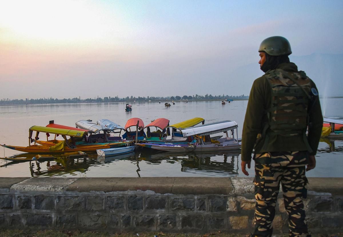 A security personnel stands guard as European Union Parliamentary delegation arrived for a shikara ride at Dal Lake in Srinagar, Tuesday, Oct. 29, 2019. Protest broke out in many parts of the City as a European Union Parliamentary delegation visited the valley. (PTI Photo/S. Irfan)(