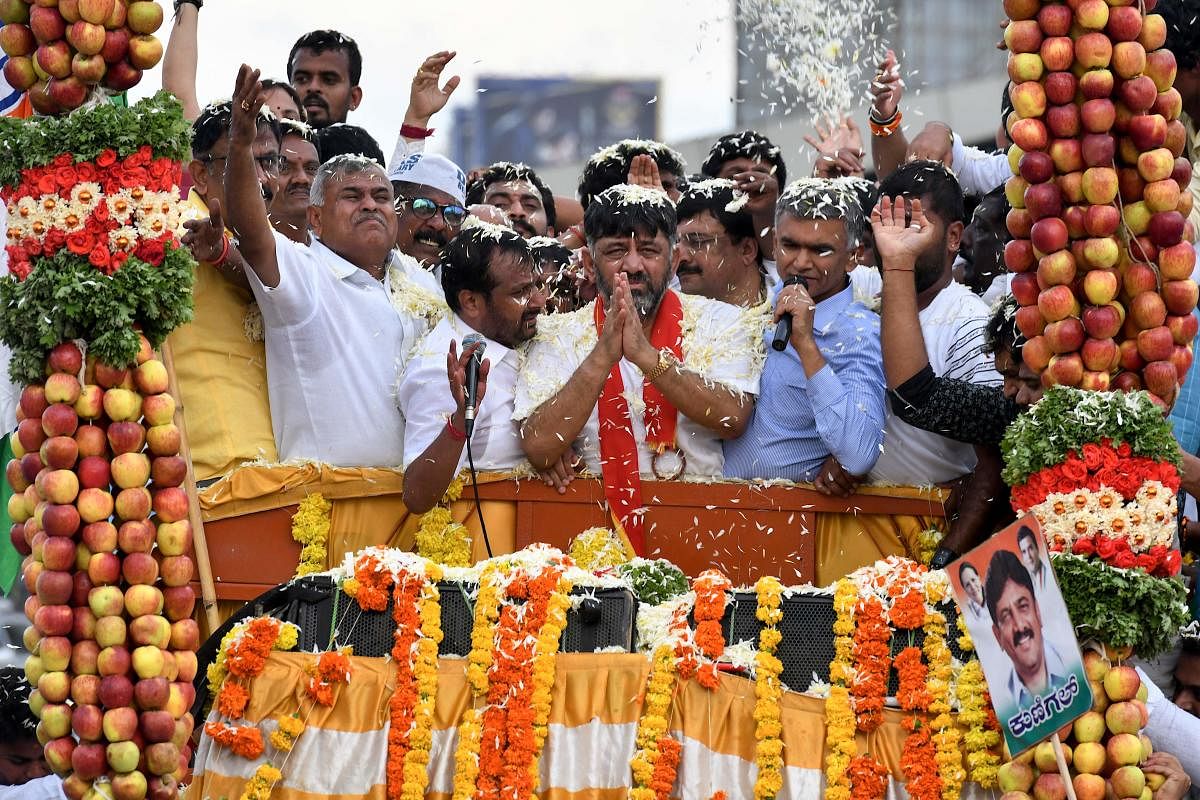 Former Karnataka Congress Minister D.K. Shivakumar (C) gestures to greet party workers. AFP file photo
