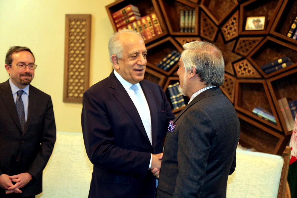 US special representative for Afghanistan, Zalmay Khalilzad shakes hand with Afghanistan Chief Executive Abdullah Abdullah in Kabul. (Reuters Photo)