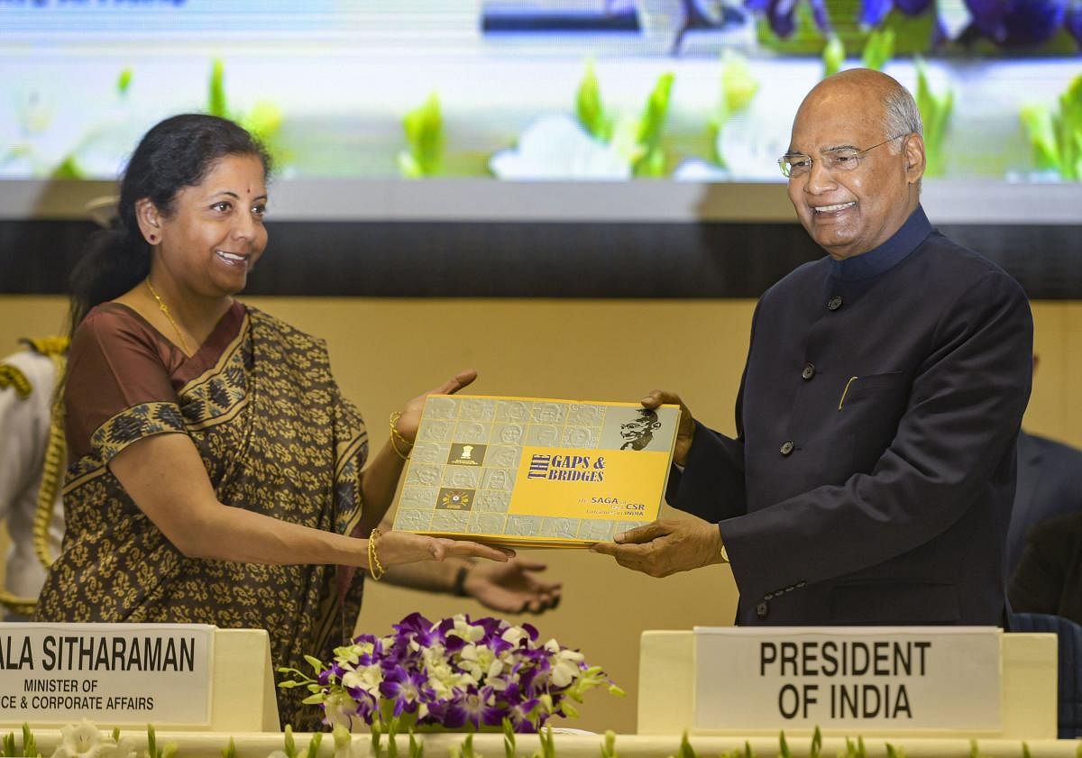 President Ram Nath Kovind being presented a book by Finance Minister Nirmala Sitharaman during the National Corporate Social Responsibility Awards function in New Delhi on Tuesday. (PTI Photo)