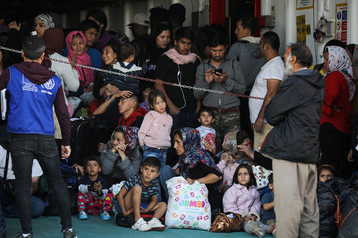 Refugees and migrants arrive on a passenger ferry from the island of Samos, at the port of Elefsina near Athens Greece (Reuters Photo)