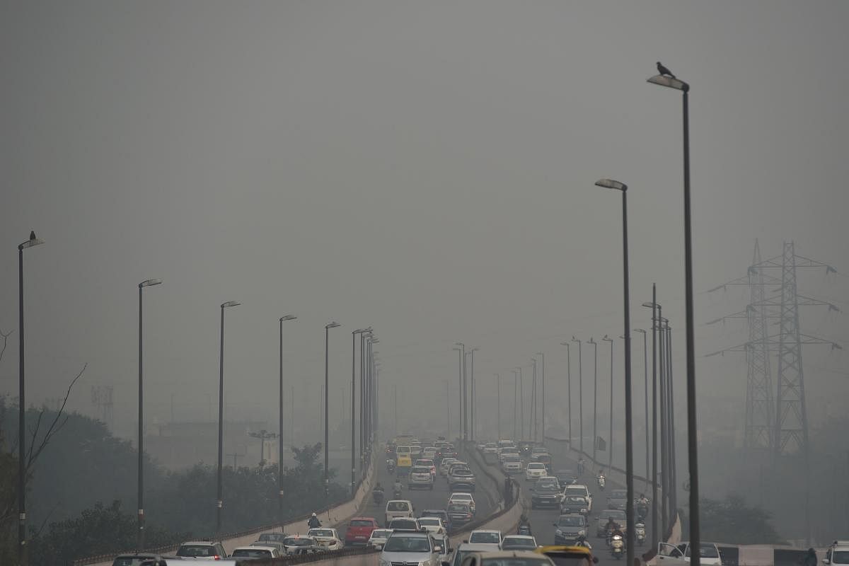 Commuters drive along a road under heavy smog conditions in New Delhi on October 30, 2019. AFP