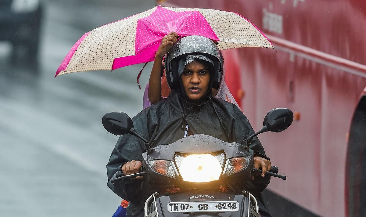 Motorists ride a bike during heavy rainfall following the onset of North East Monsoon across the state, in Chennai, Wednesday, Oct. 30, 2019. (PTI Photo/R Senthil Kumar)