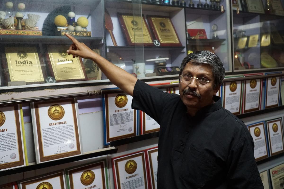 Dr S Ramesh Babu, a retired metallurgical scientist and world record holder poses in his home points to shuttle cocks used in record-breaking attempt. DH Photo