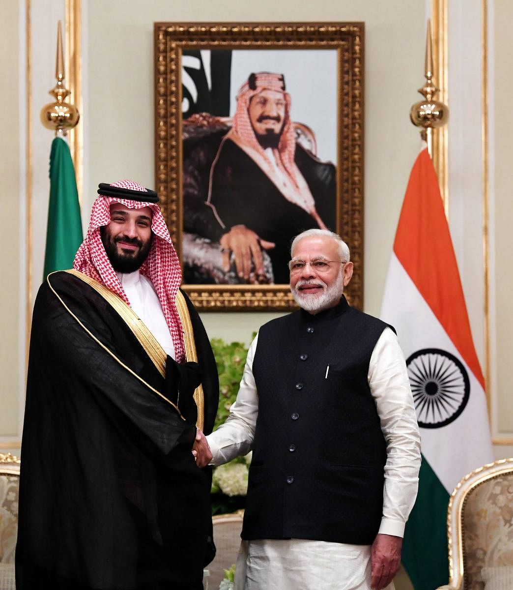 Prime Minister Narendra Modi and Saudi Arabia's Crown Prince Mohammed bin Salman shaking hands in Riyadh. (Photo by Handout / PIB / AFP)