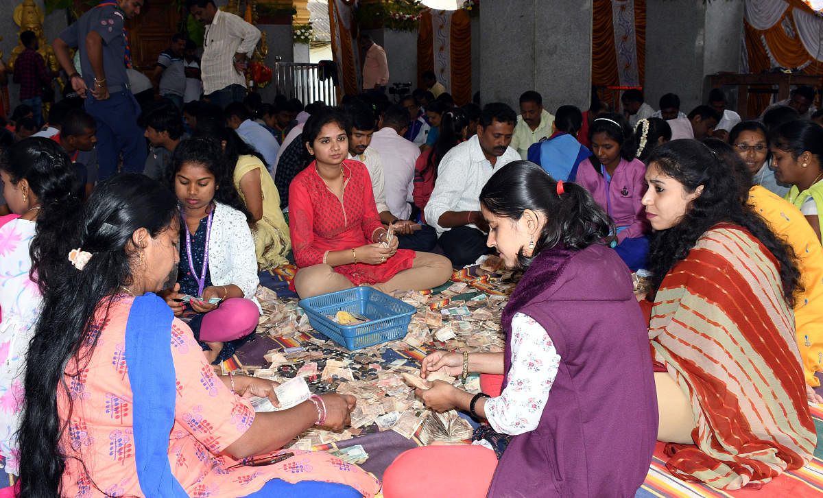 Bank employees count the offerings at Hasanamba temple in Hassan on Wednesday. dh photo