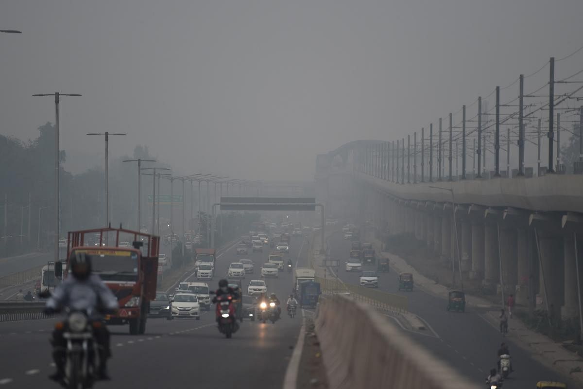 Commuters drive along a road under heavy smog conditions in Faridabad. (AFP Photo)