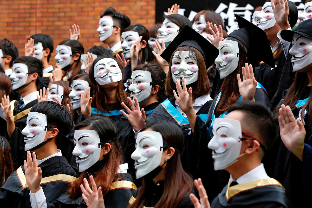University students wearing Guy Fawkes masks pose for a photoshoot of a graduation ceremony to support anti-government protests at the Hong Kong Polytechnic University, in Hong Kong (Reuters Photo)