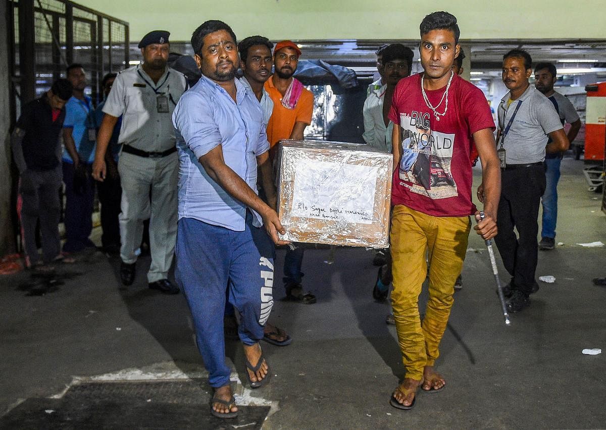 Coffins containing bodies of the five labourers from Murshidabad district of West Bengal, who were allegedly killed in a militant attack in south Kashmir's Kulgam district, arrive at NSCBI Airport in Kolkata, Wednesday, Oct. 30, 2019. (PTI Photo)