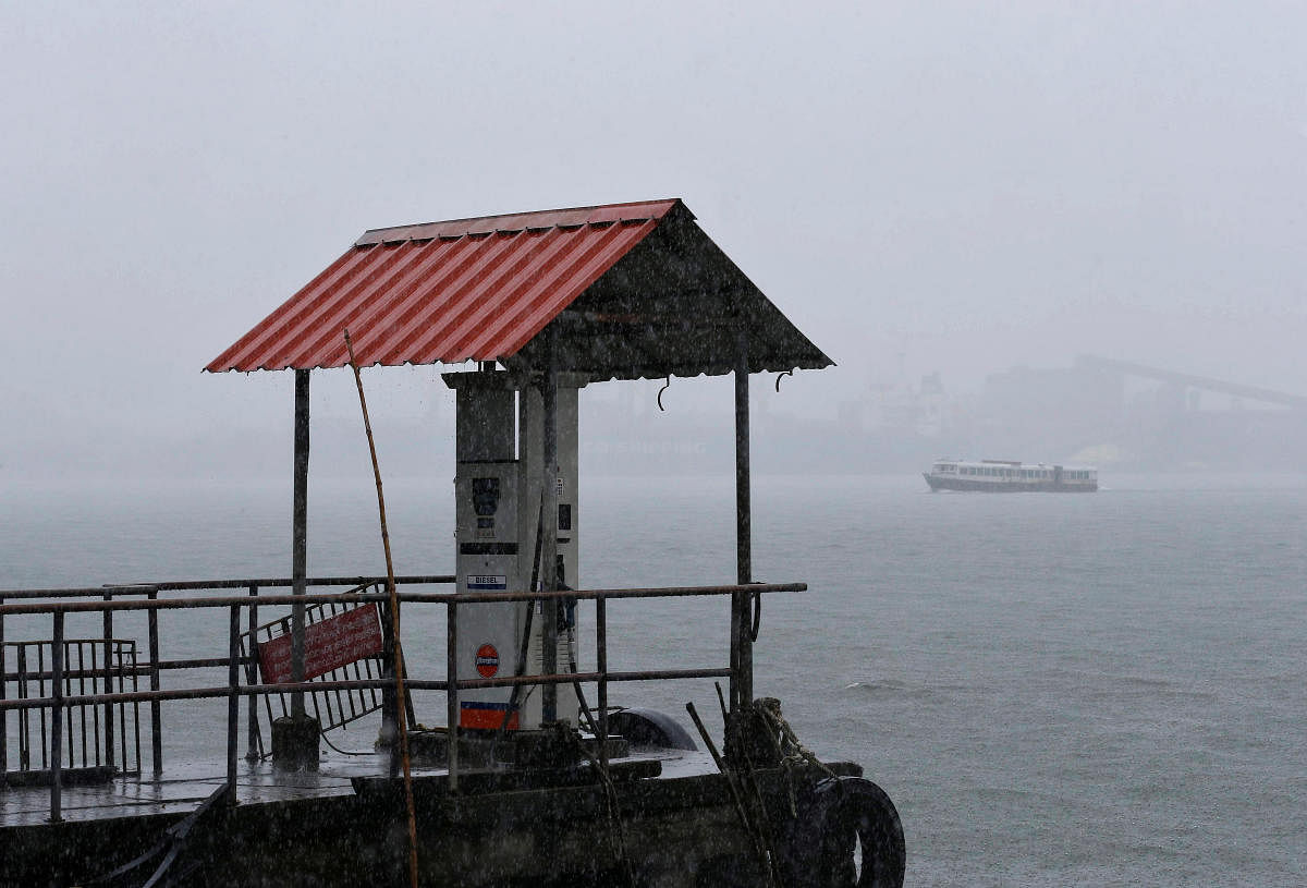 A passenger boat moves past a fuel pump in the waters of Vembanad Lake during heavy rains caused by Cyclone Maha in Kochi, India, October 31, 2019. REUTERS/Sivaram V