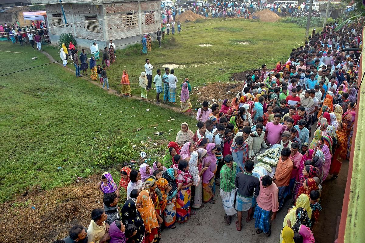 Villagers gather as bodies of five labourers, who were killed in a militant attack in south Kashmir's Kulgam district, are brought at Bahelnagar village in Murshidabad district of West Bengal on Thursday. (PTI Photo)