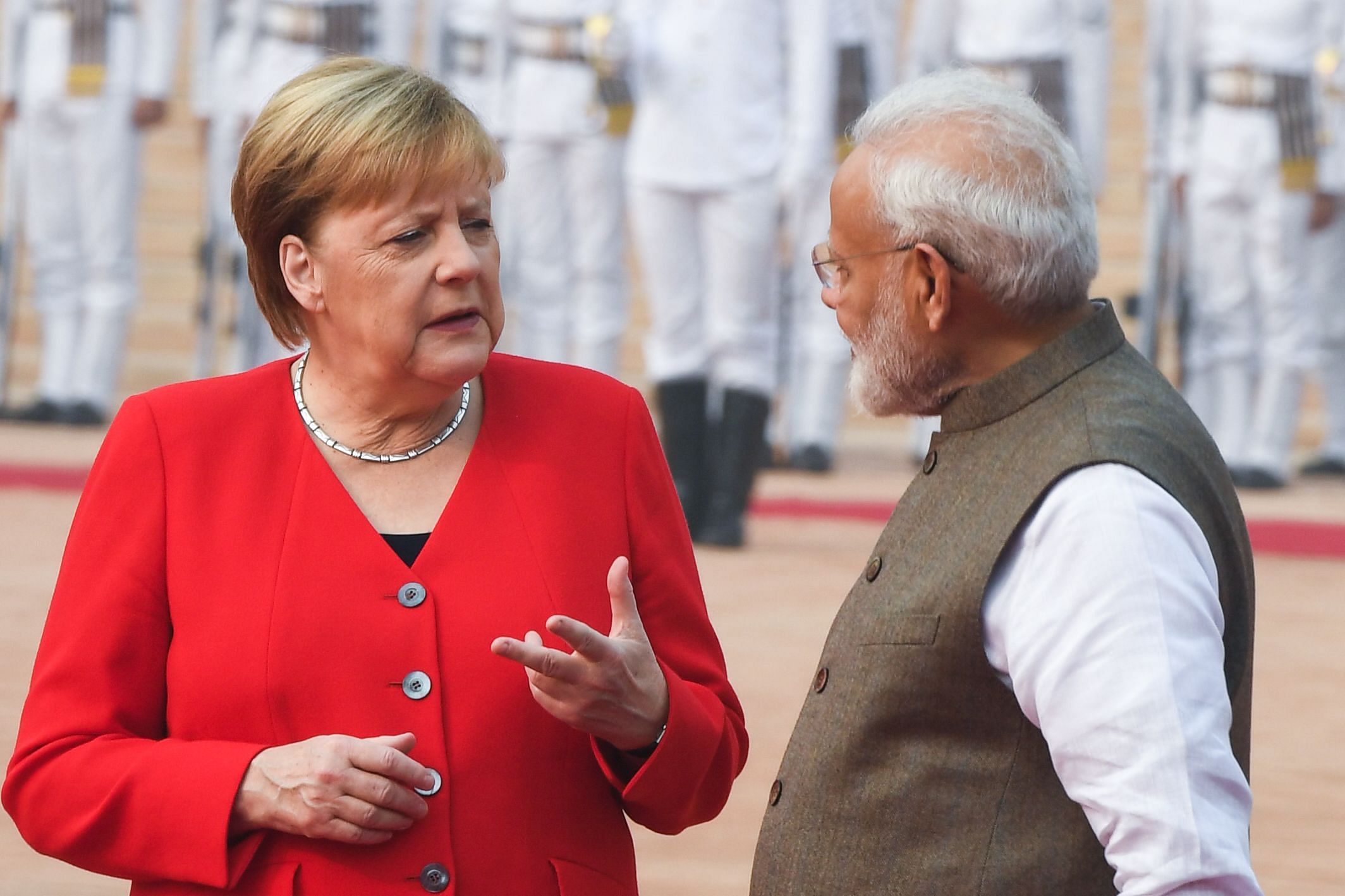 India's Prime Minister Narendra Modi (R) listens to German Chancellor Angela Merkel during a welcoming ceremony at Rashtrapati Bhavan. (AFP Photo)