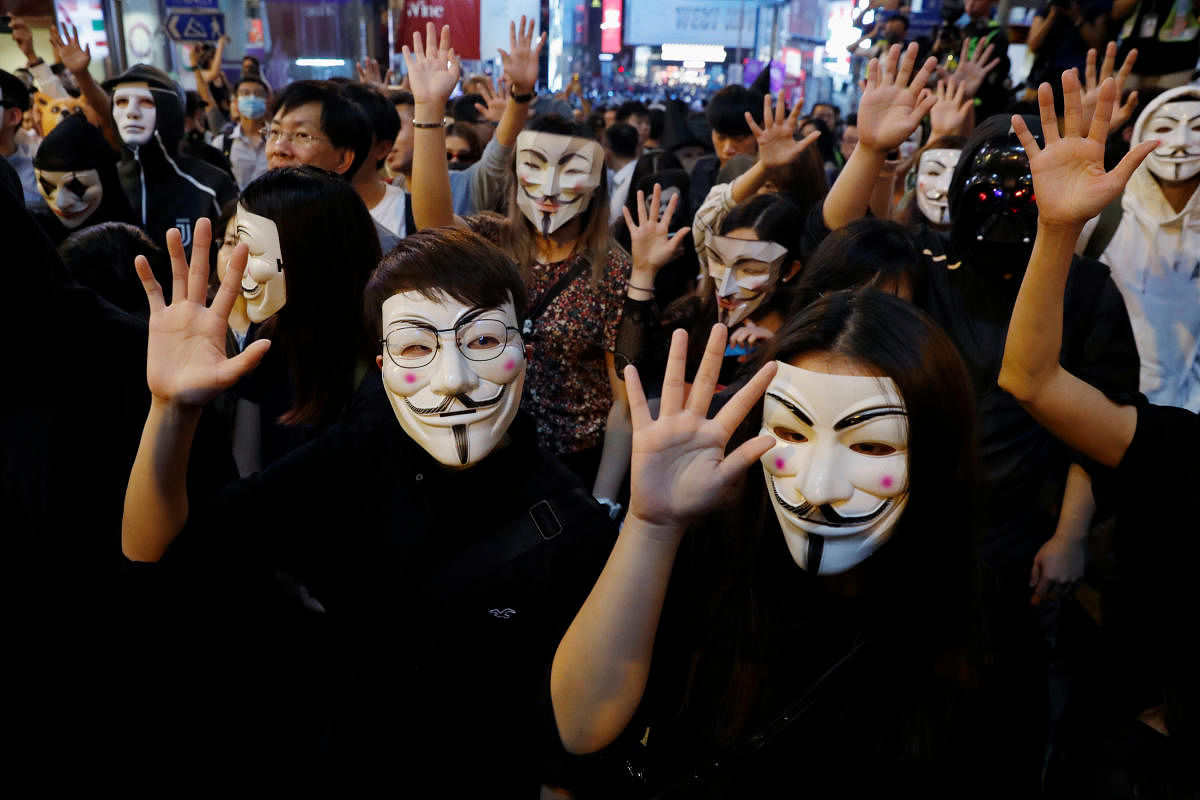 Anti-government protesters wear Guy Fawkes masks during a Halloween march in Lan Kwai Fong (Reuters Photo)