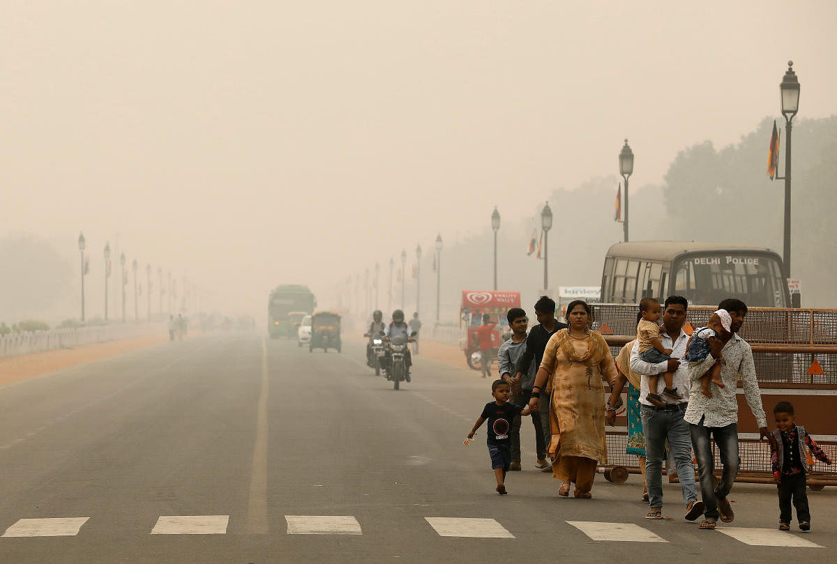 People walk on the Rajpath on a smoggy day in New Delhi, India. Reuters
