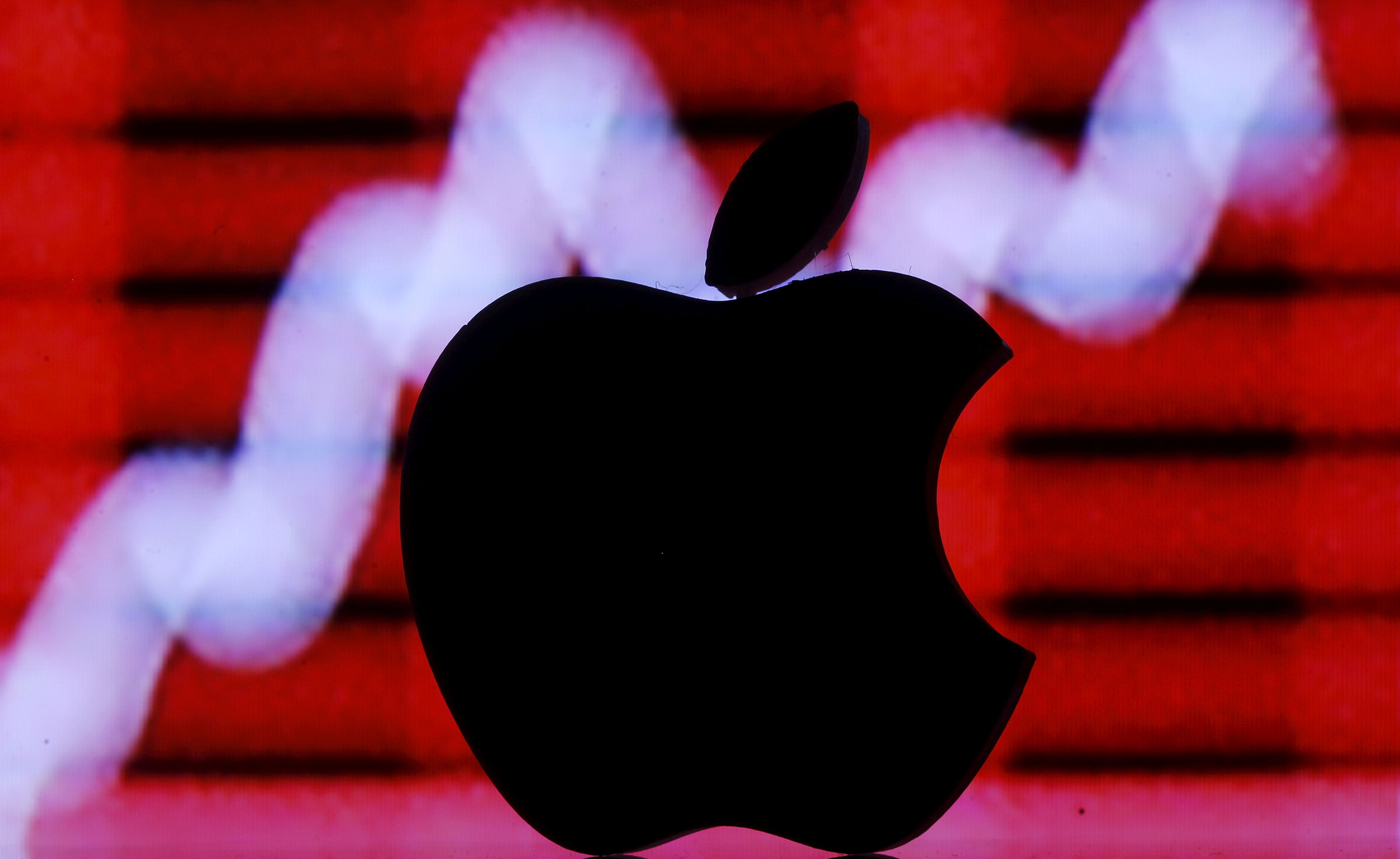 Picture illustration of a 3D printed Apple logo in front of a displayed stock graph (Reuters File Photo)