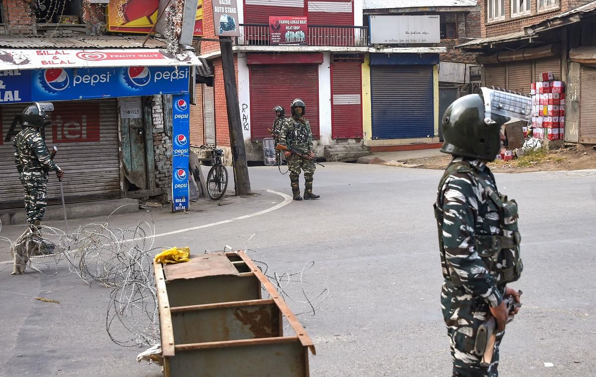 Security personnel stand guard during restrictions in the parts of Downtown in Srinagar, Friday, Nov. 1, 2019. PTI