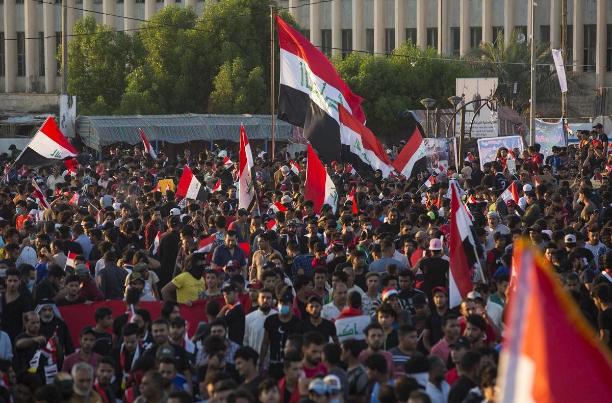 Iraqis take part in an anti-government protest in the southern city of Basra on November 1, 2019. - Iraq's top cleric warned foreign actors today against interfering in his country's anti-government protests as they entered a second month despite pledges