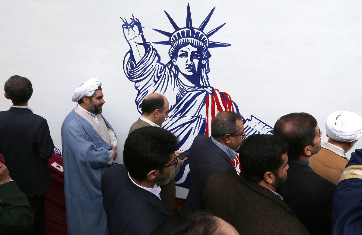 Iranians take part in an inaugural ceremony unveiling the new murals painted on the walls of the former US embassy in the capital Tehran on November 2, 2019. AFP