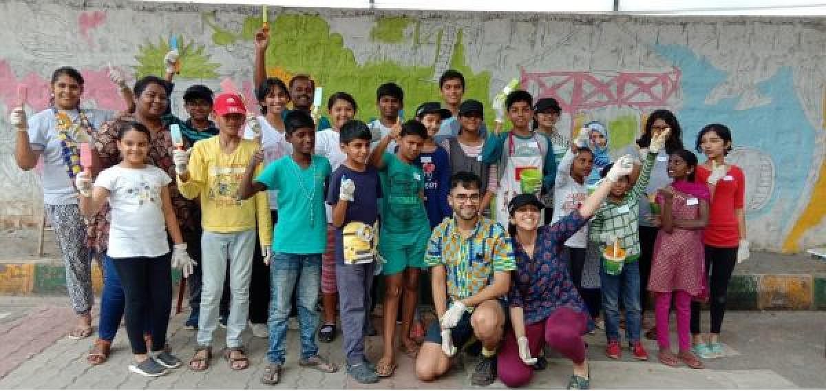Students of Clarence High School, kids living in the Richards Town and the children of pourakarmikas painted the railway wall in an attempt to clean up the neighbourhood.