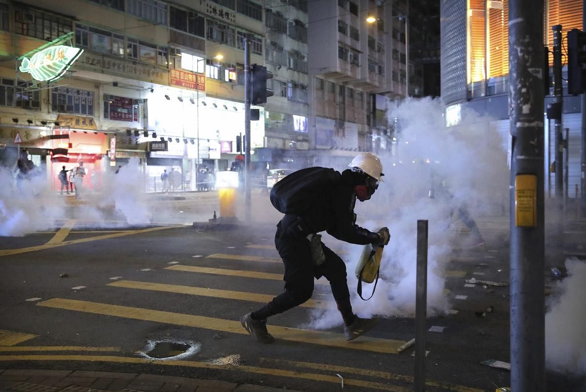  A demonstrator reacts as police fire tear gas during a protest in Hong Kong (AP/PTI Photo)