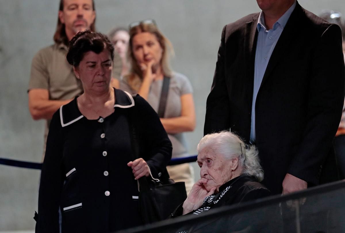 World War II rescuer Melpomeni Dina (R) waits to be reunited with holocaust survivors Yossi Mor and his sister Sarah Yanai (unseen) whom she helped escape in 1943, at the Hall of Names at the Yad Vashem Holocaust Memorial museum in Jerusalem on November 3, 2019. (Photo by EMMANUEL DUNAND / AFP)
