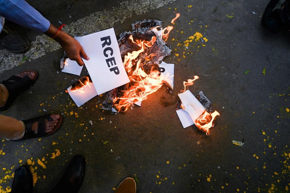 A protestor burns placards during a demonstration against the government's plan to join the Regional Comprehensive Economic Partnership (RCEP) (AFP Photo)
