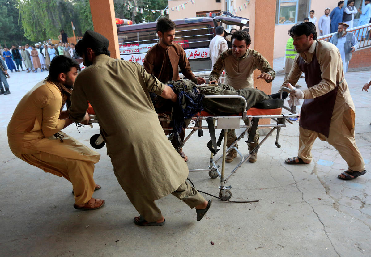 Men carry an injured person to a hospital after a blast in Jalalabad, Afghanistan. (Photo by Reuters)