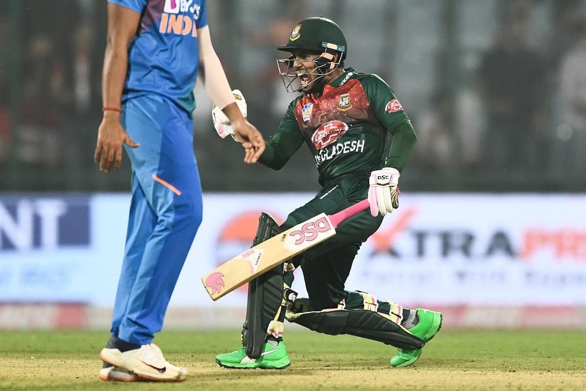 Bangladesh's Mushfiqur Rahim (R) celebrates his victory at the end of the first T20 international cricket match of a three-match series between Bangladesh and India, at Arun Jaitley Cricket Stadium in New Delhi on November 3, 2019. (Photo by AFP)