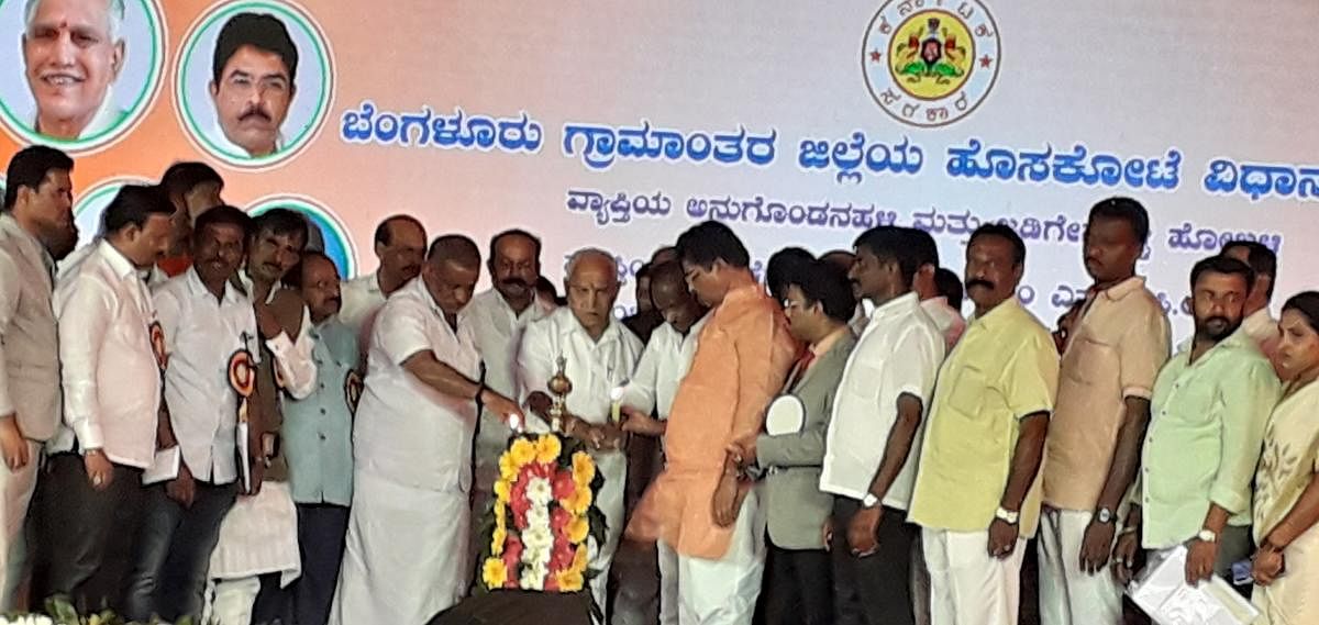 Chief Minister B S Yediyurappa launches development projects in Hoskote, Bengaluru Rural district on Monday. Ministers J C Madhuswamy, R Ashoka, disqualified MLA M T B Nagaraj and others were present.