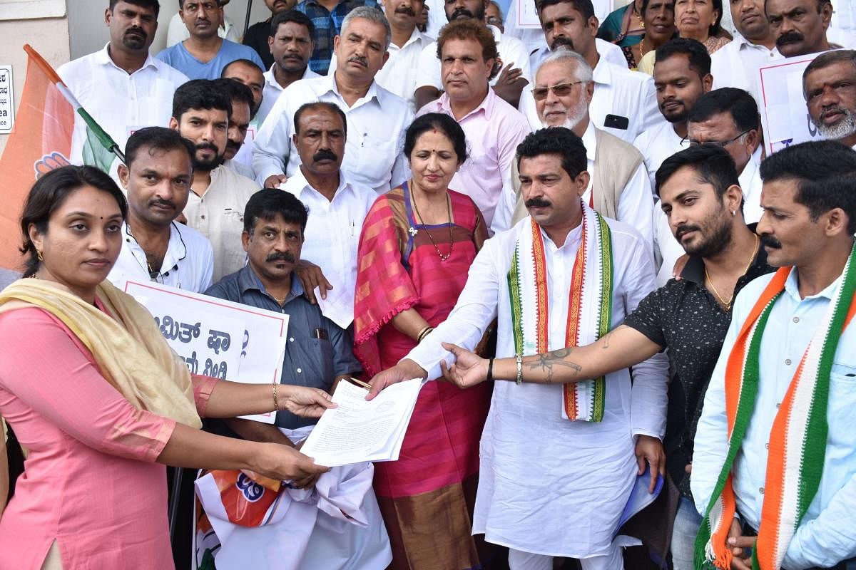 Congress leaders submit a memorandum to Additional Deputy Commissioner Dr Sneha on the premises of the DC’s office in Madikeri on Monday.