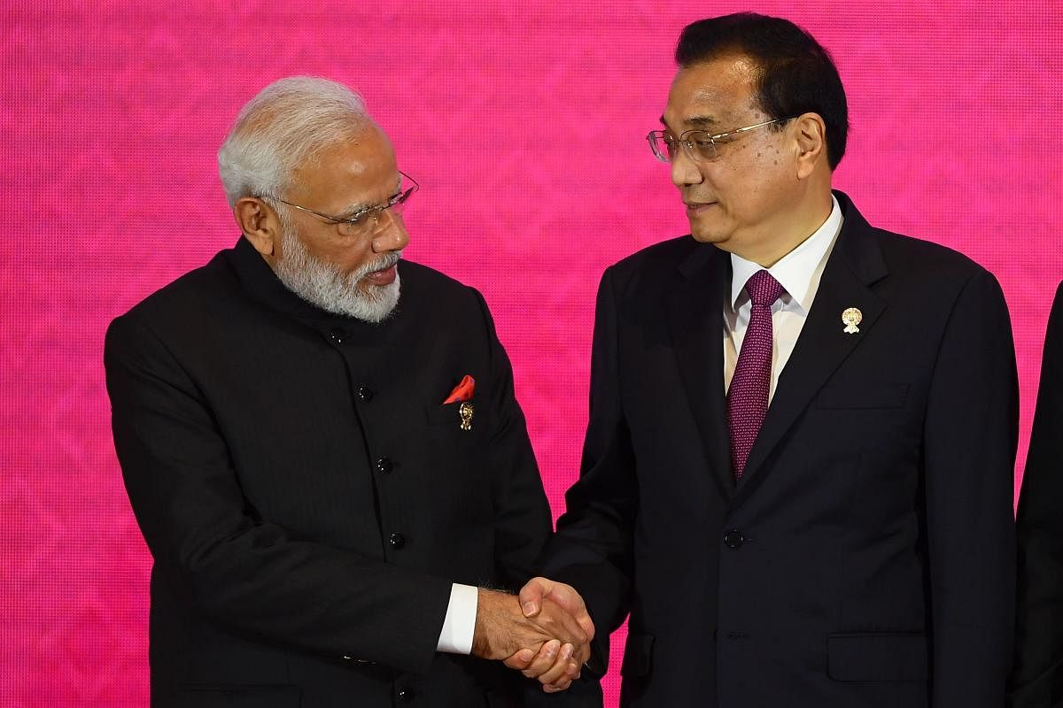 India's Prime Minister Narendra Modi shakes hands with China's Premier Li Keqiang during the 3rd Regional Comprehensive Economic Partnership (RCEP) Summit in Bangkok on November 4, 2019, on the sidelines of the 35th Association of Southeast Asian Nations
