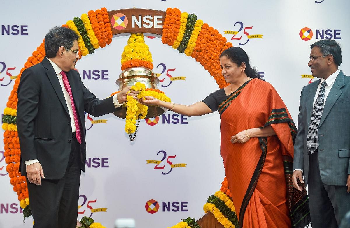 Union Finance Minister Nirmala Sitharaman and SEBI Chairman Ajay Tyagi ring a bell to conclude the Silver Jubilee celebrations of NSE, in Mumbai, Tuesday, Nov. 5, 2019. Also seen is National Stock Exchange MD &amp; CEO Vikram Limaye. (PTI Photo)